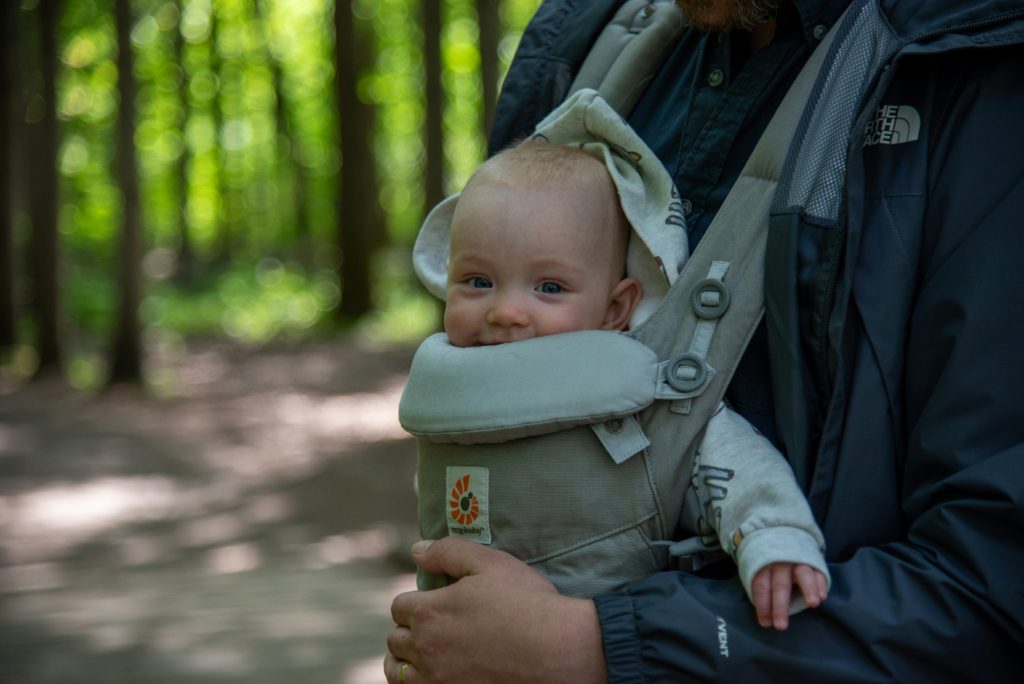 baby in carrier at park outdoor adventures you can actually do with a newborn
