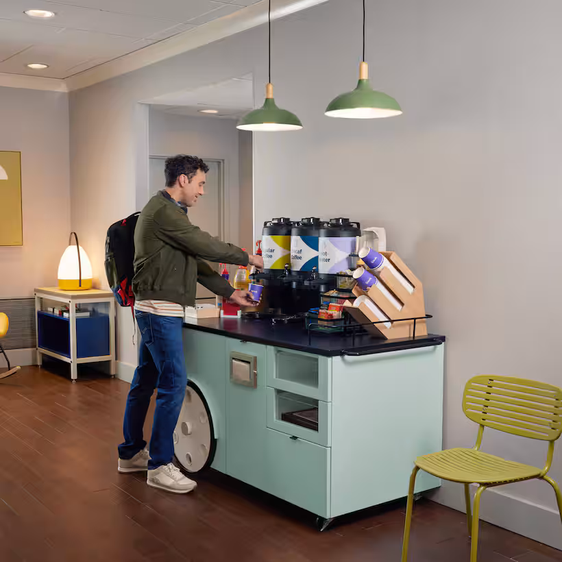 Focus: Peak of Summer TravelsKw: Best Affordable Hotels for Family Road Trips man getting coffee