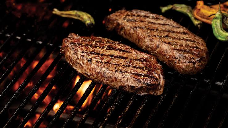 backyard bbq planning Grilling STeaks on the grill