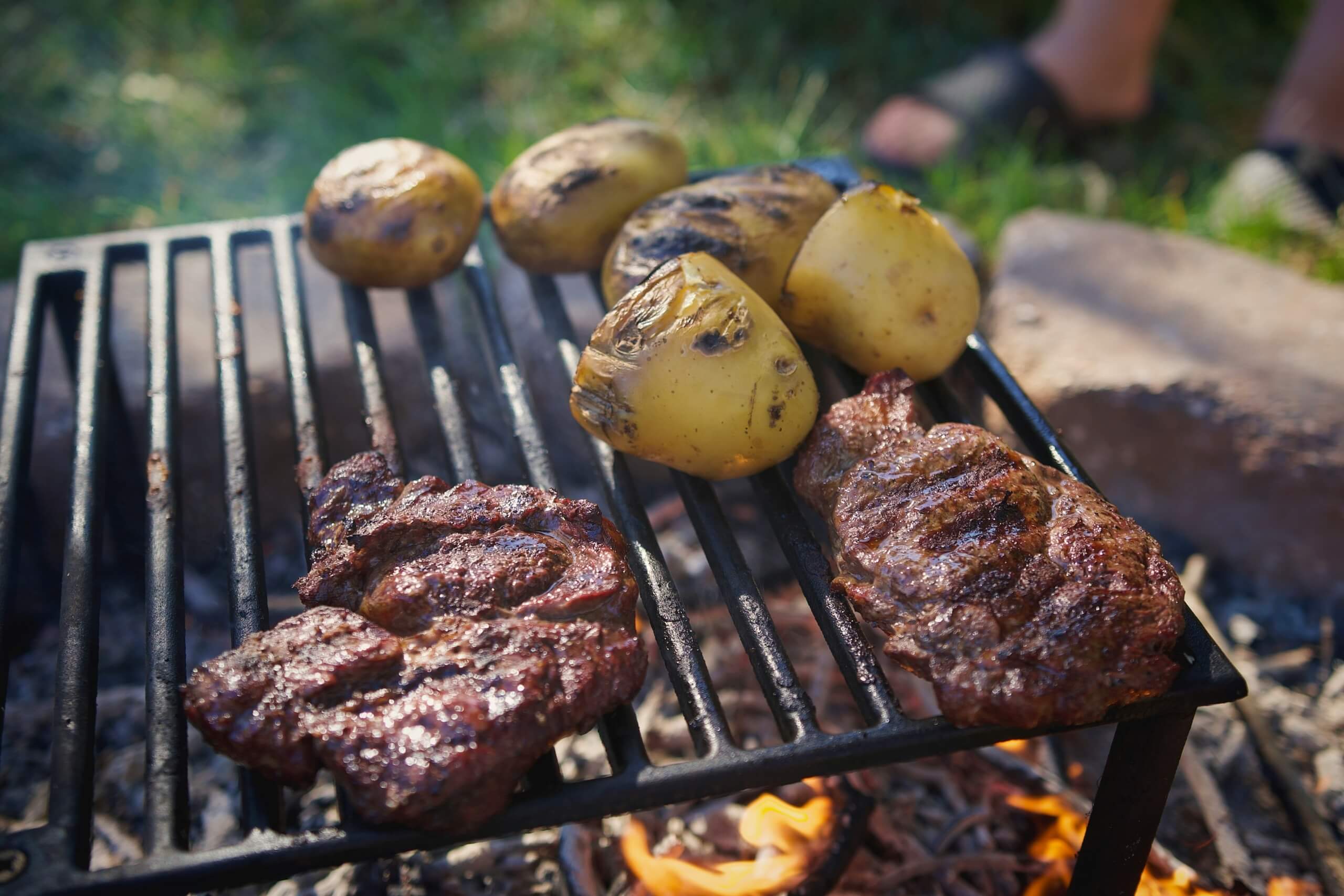 steak and potatoes over a campfire camping meals for families
