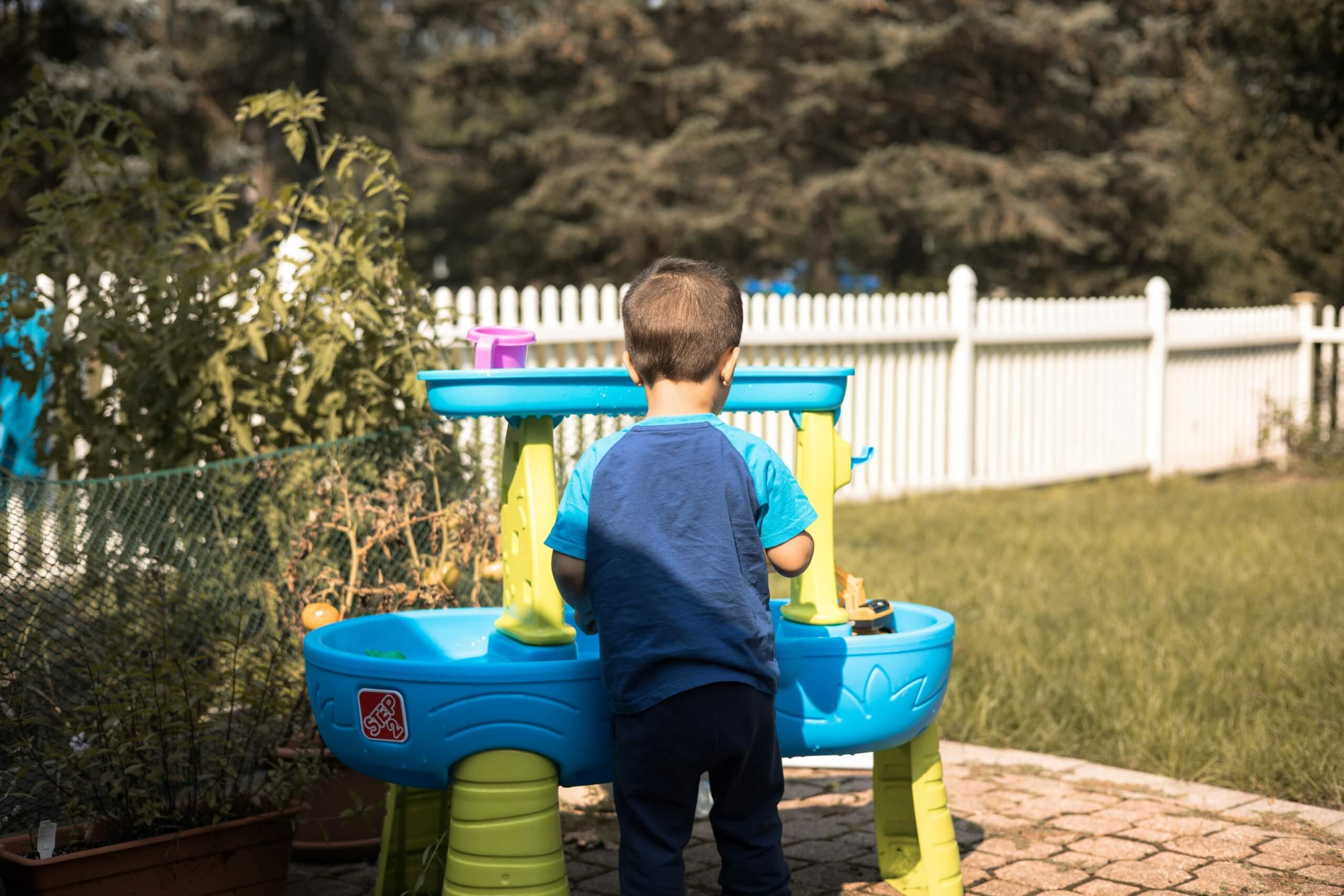 kid playing outside outdoor games water games water table summer backyard refresh ideas