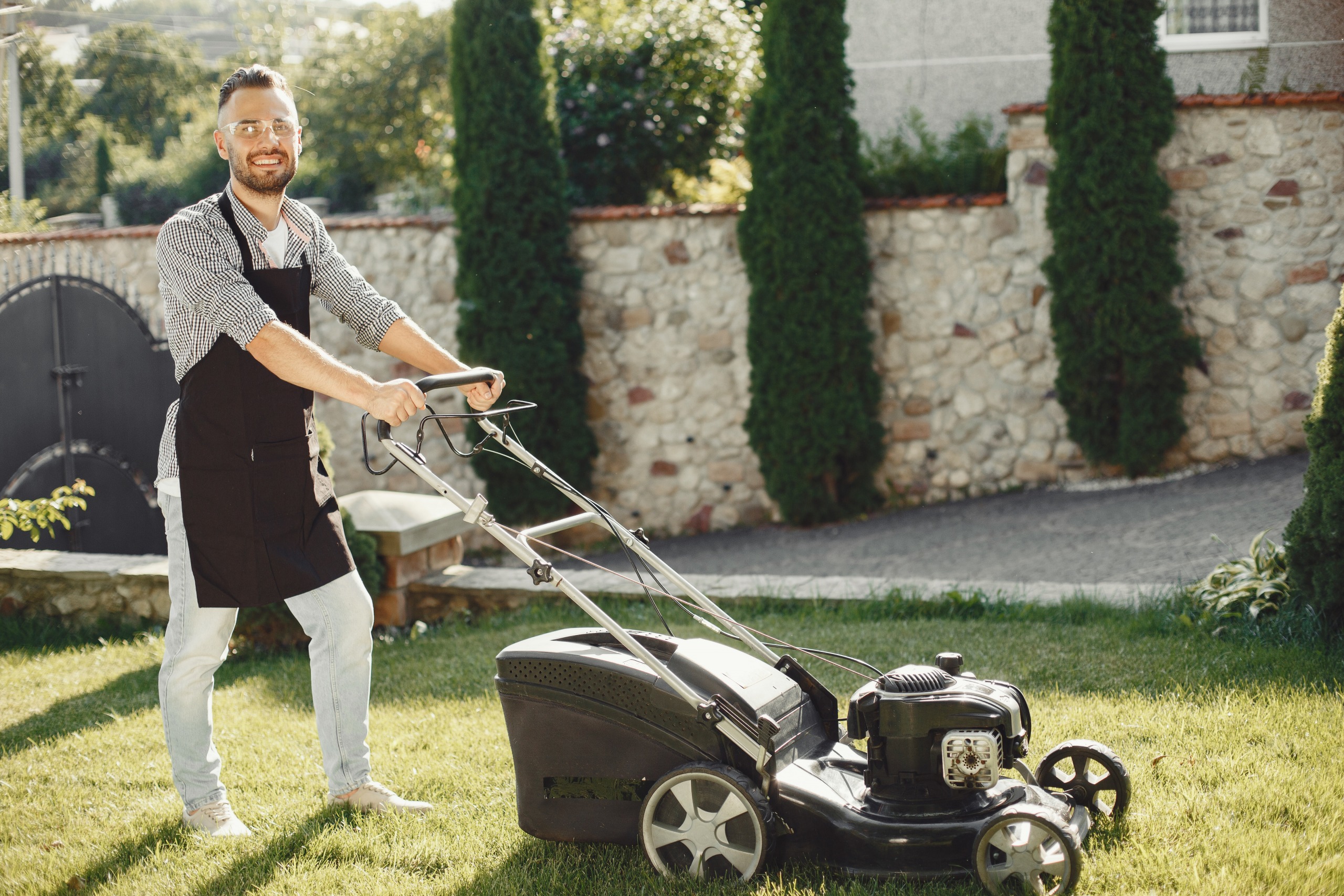 backyard renovations summer backyard refresh ideas man mowing his backyard