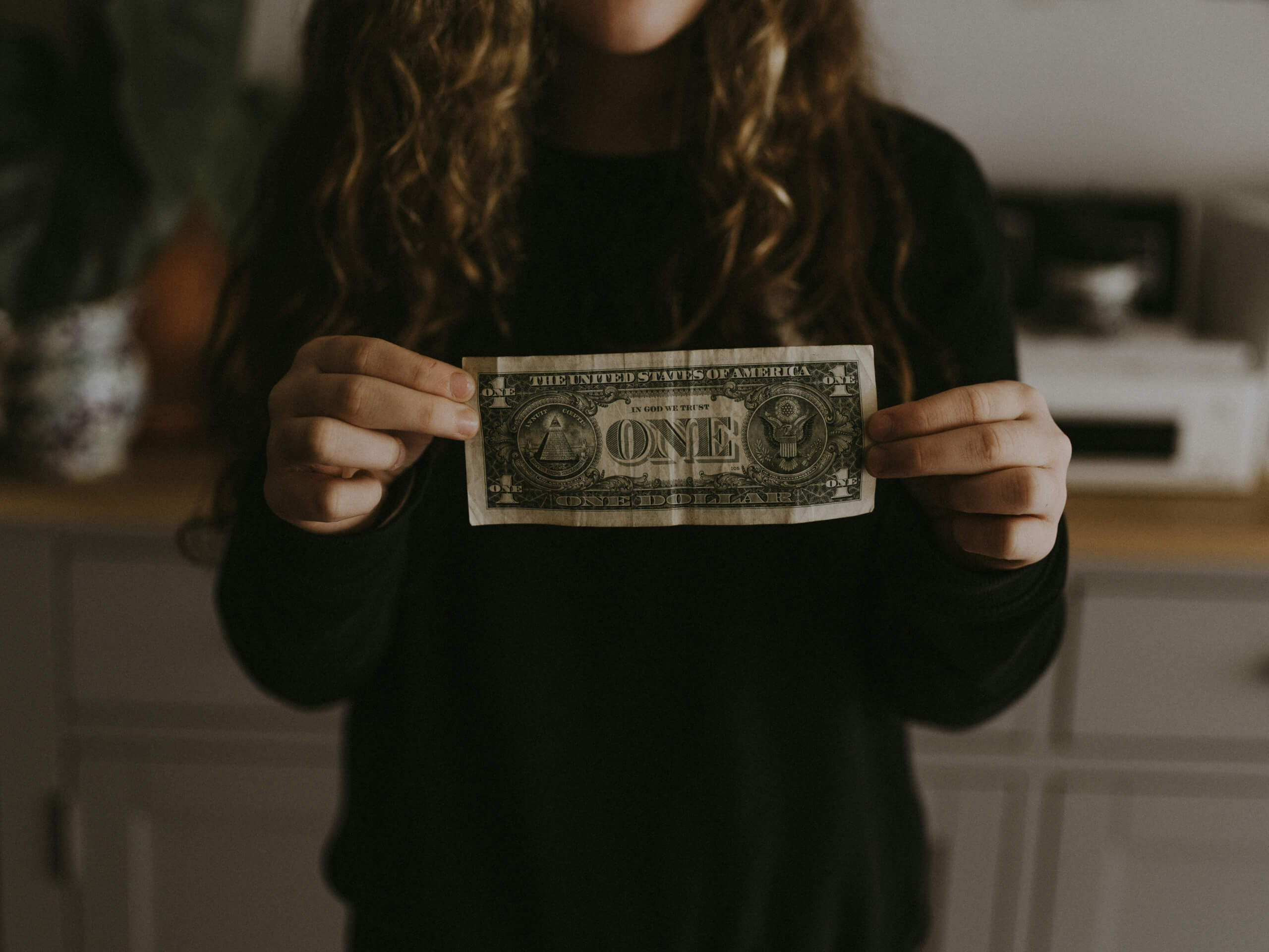 teen holding cash - money management for teens