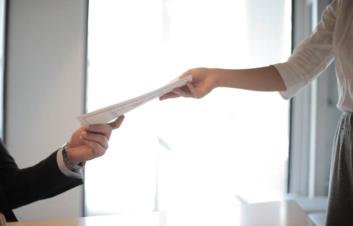 Job Applicant Passing Her Documents - employment reference letter