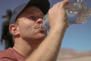 man drinking water - tips for safe family biking