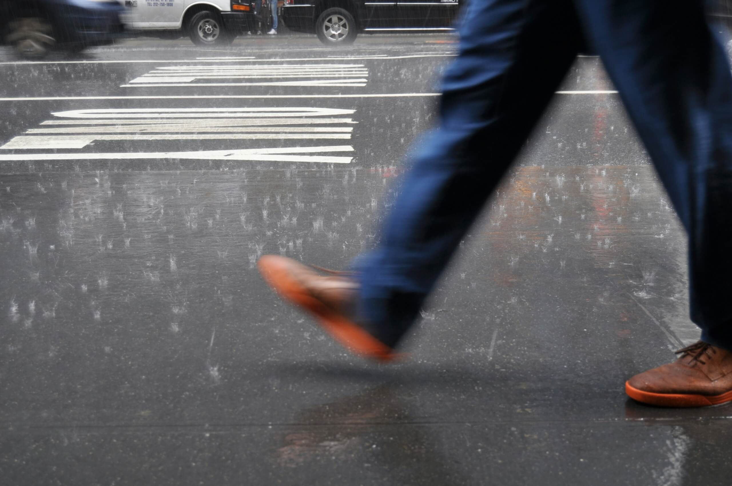 waterproof sneakers - man walking in rain