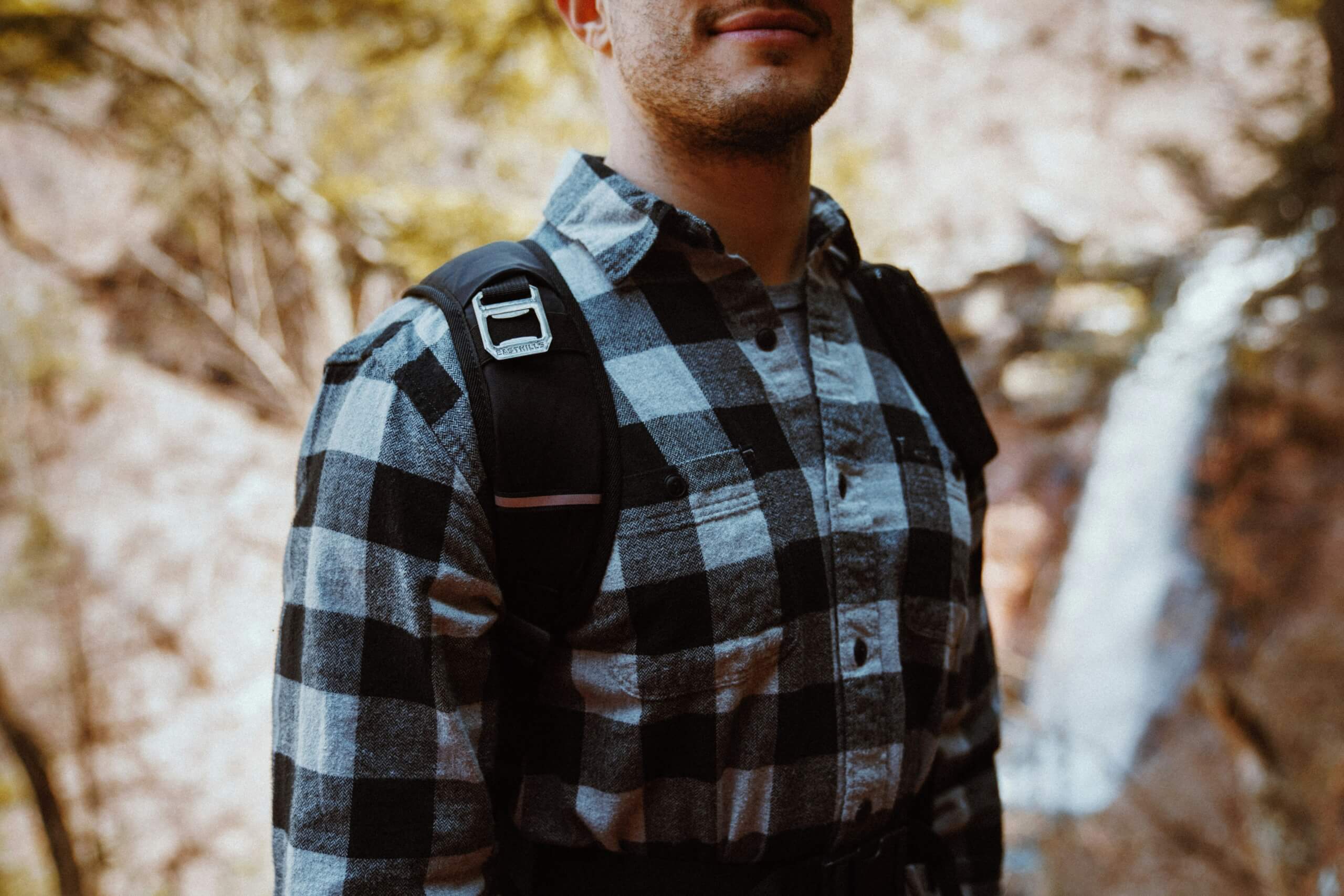 man hiking in flannel shirt