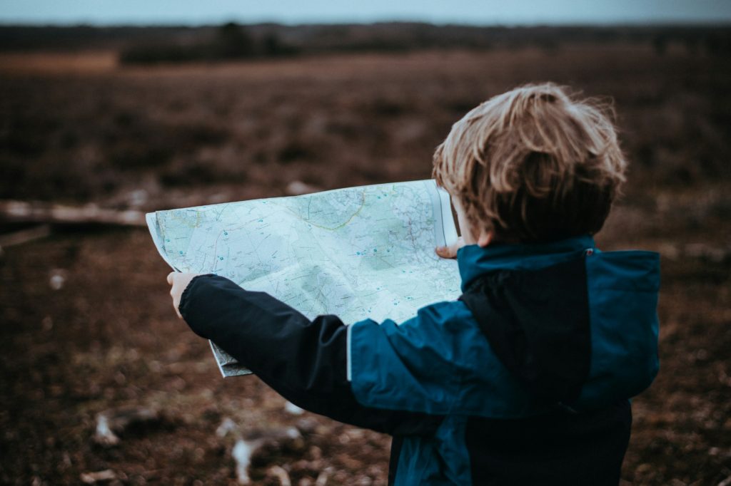 family roadtrip framework kid looking at map traveling 