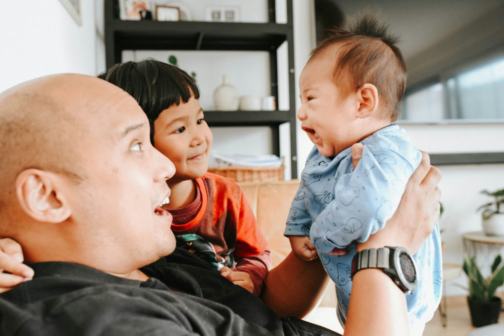 dad with kids and baby investing for kids future