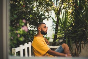 mens' summer outdoor outfits man sitting outside on bench