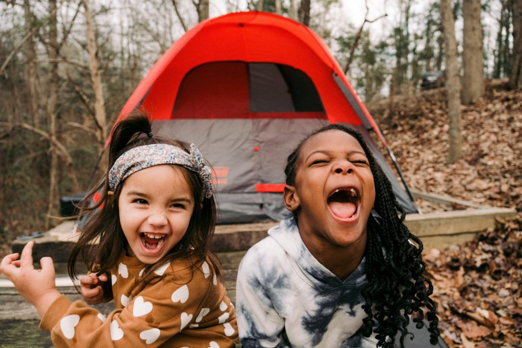 little girls camping outdoors 