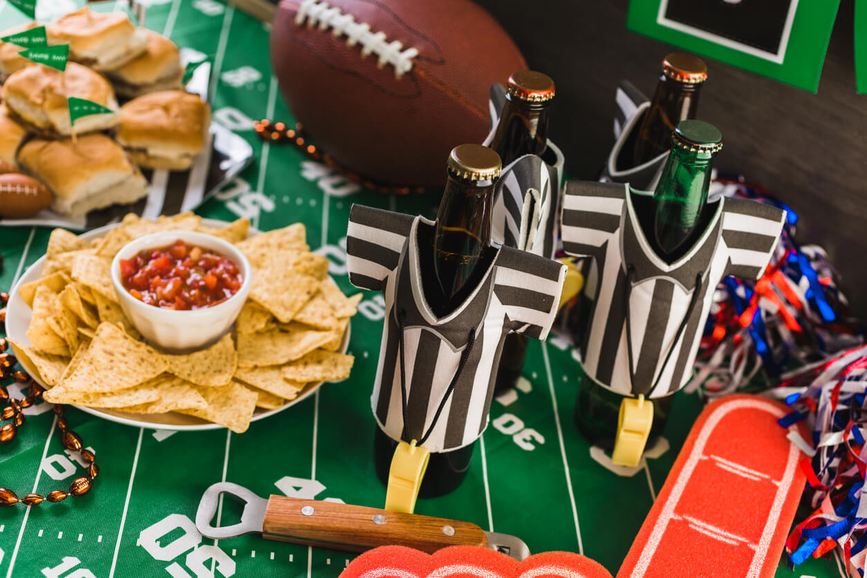 Game day football party table with beer, chips and salsa. football watch party food ideas