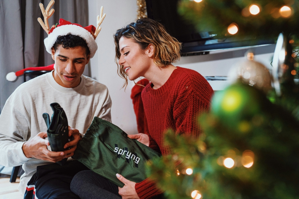 man opening christmas gifts presents Photo by Michael DeMoya on Unsplash