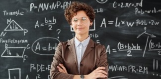 Photo Of Woman Standing In Front Of Blackboard - career change for teachers