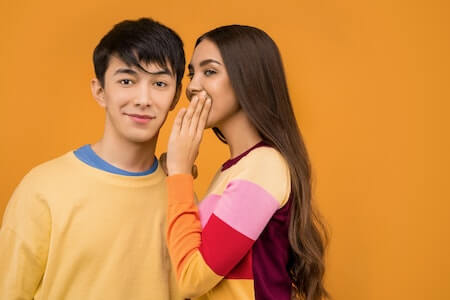 Woman Whispering to Man - now hiring
