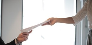 Job Applicant Passing Her Documents - employment reference letter
