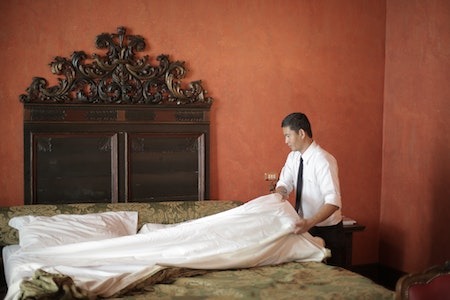 Hard Working Man Changing the Bed Sheet - winter seasonal jobs