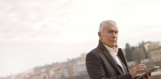 Elderly Man in Black Coat Standing Near Brown Concrete Wall - black coats for men