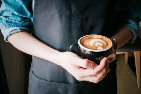 Woman Holding Mug of Cappuccino - part time evening jobs