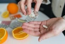 Person taking pill - biotin supplement options