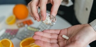 Person taking pill - biotin supplement options