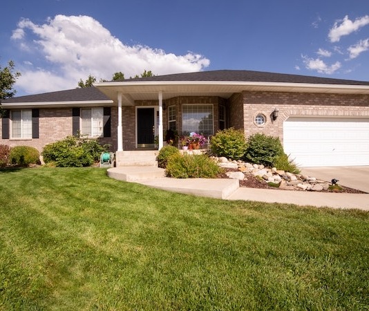 Green Grass Lawn Near White and Brown House Under Blue Sky - front yard hedge ideas