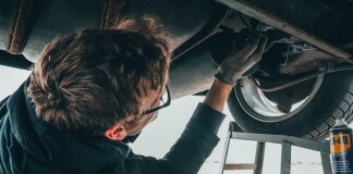 Man Fixing Vehicle Engine - preparing car for road trip