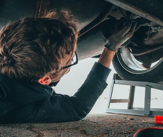 Man Fixing Vehicle Engine - preparing car for road trip