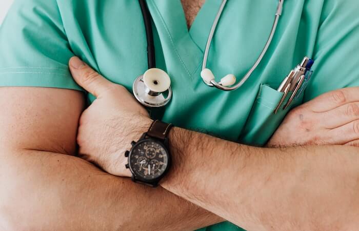 Crop unrecognizable male doctor with stethoscope - finding a sexual health clinic