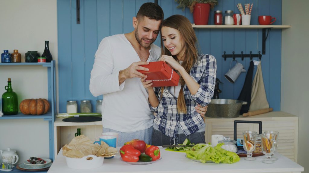 man giving woman a gift mother's day gifts from husband