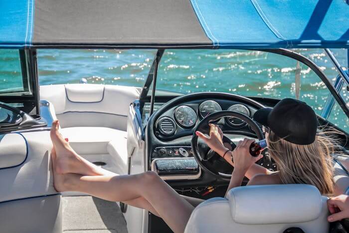 boat accessories featured image woman driving boat