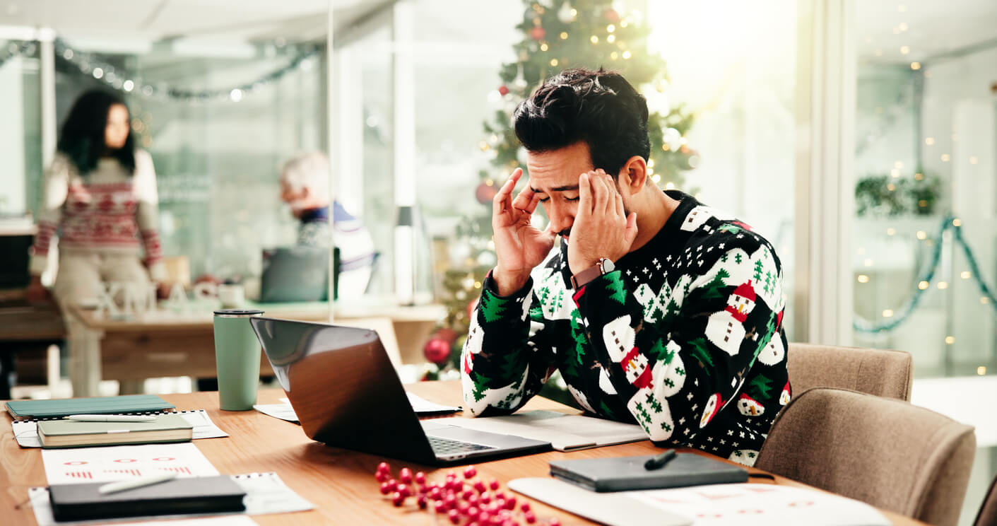 Headache, christmas and businessman in office with laptop for stress, burnout or fatigue for workload. Exhaustion, tired and financial advisor with migraine for documents and computer in xmas season. Work Life Balance During the Holiday Season