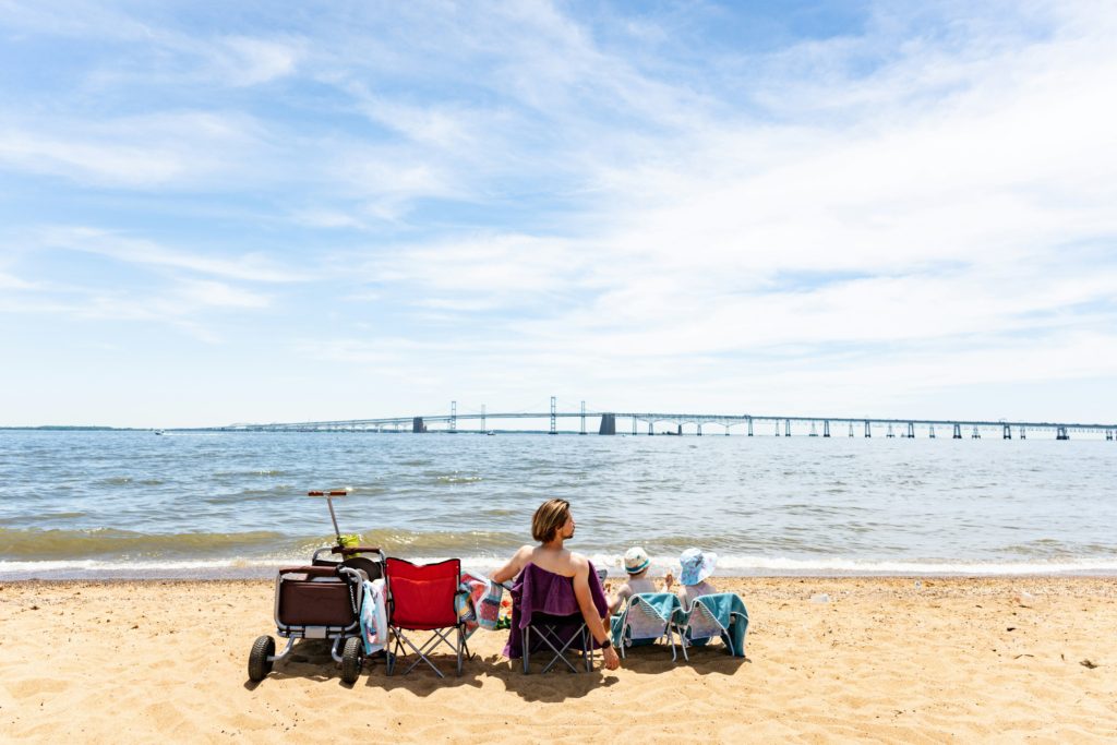 man on the beach with kids best coolers for beach