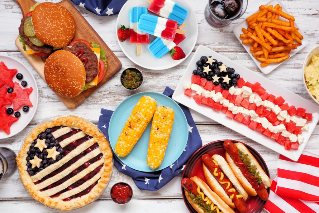 4th of july backyard party ideas Fourth of July, patriotic, American themed food. Above view table scene on a white wood background.
